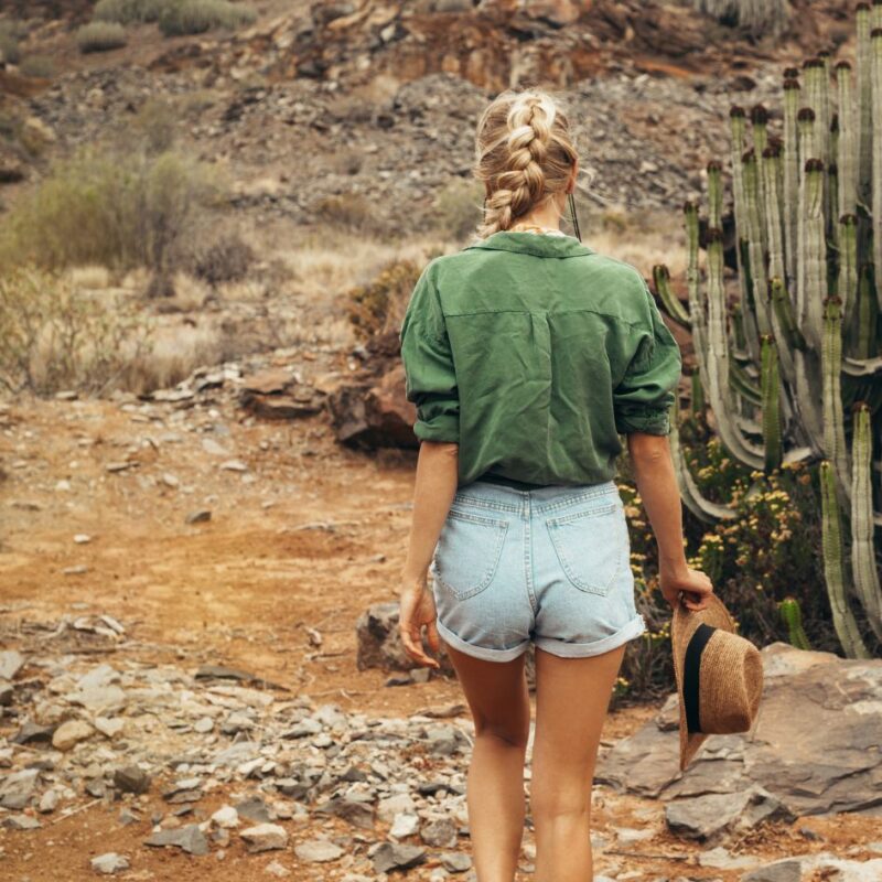 Authentic Self by Dawn Francis_Rebel-Faith-Poetry_woman walking on gravel rocky road with cactus